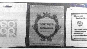 Drei Tragetaschen mit Logos von den Läden „Coop“, „Boutique Susanne“ und der Marke „Feh“.